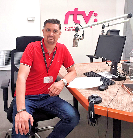 Radio presenter sitting at a studio desk